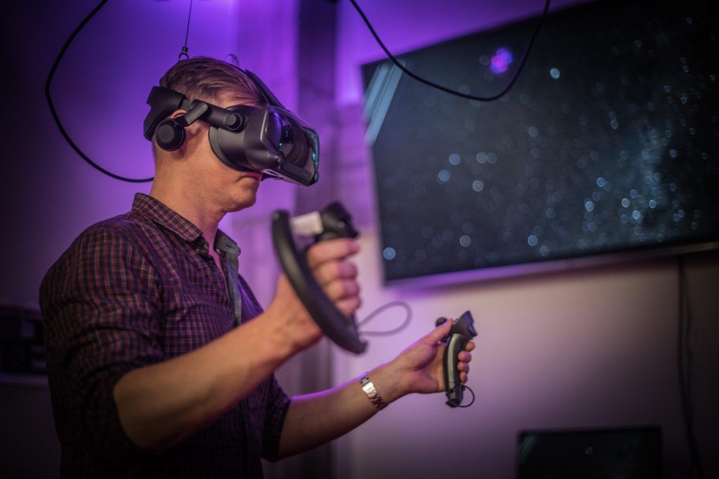 A person with VR headset and controllers